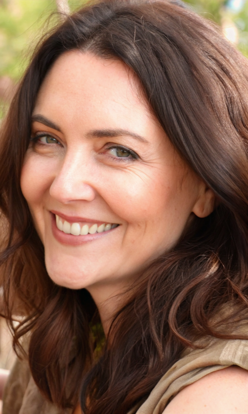 Smiling Callie Brooks with long brown hair and soft natural lighting
