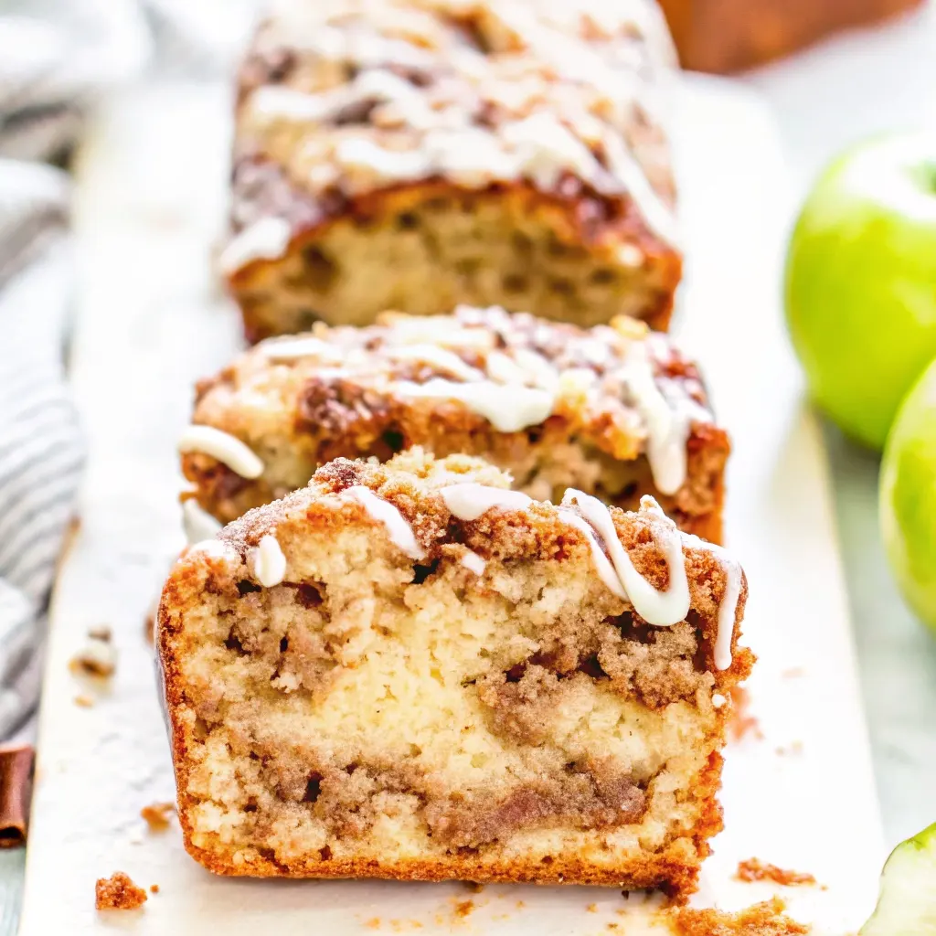 Amish Apple Fritter Bread Recipe Amish Apple Fritter Bread A close-up of a thick slice of moist Amish Apple Fritter Bread, showing the gooey cinnamon swirl inside and a sweet vanilla glaze drizzled on top.