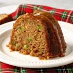 The Best Pecan Zucchini Bundt Cake Pecan Zucchini Bundt Cake A slice of moist pecan zucchini bundt cake on a white plate with a brown sugar glaze dripping down the side.